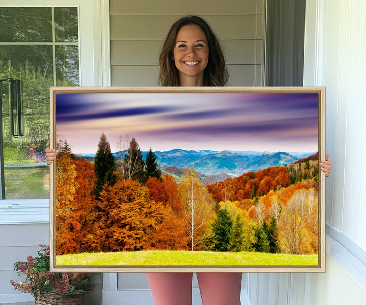 The wall art in the kitchen dining area is a large Autumn Forest Mountain Canvas Print that captures a vivid scenic landscape.