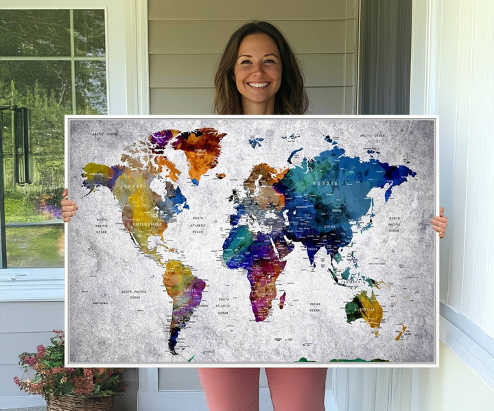 The World Map Art Canvas Print, featuring country names on a grunge-stained gray background, is perfect for stylish home decor.