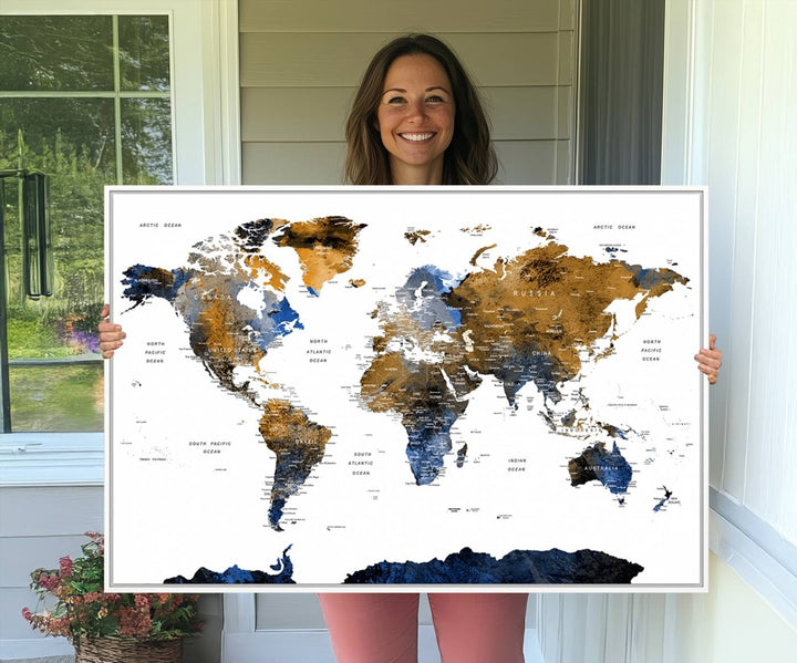 The Watercolor World Map Canvas showcases a grunge-stained background in gold, gray, and blue hues.