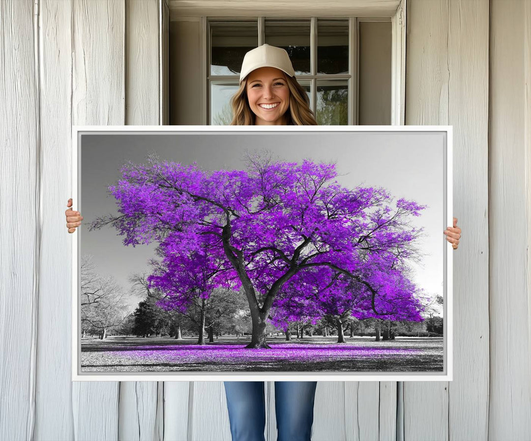 The Big Purple Tree Wall Art Canvas Print showcases a vibrant purple tree set against a black-and-white landscape.