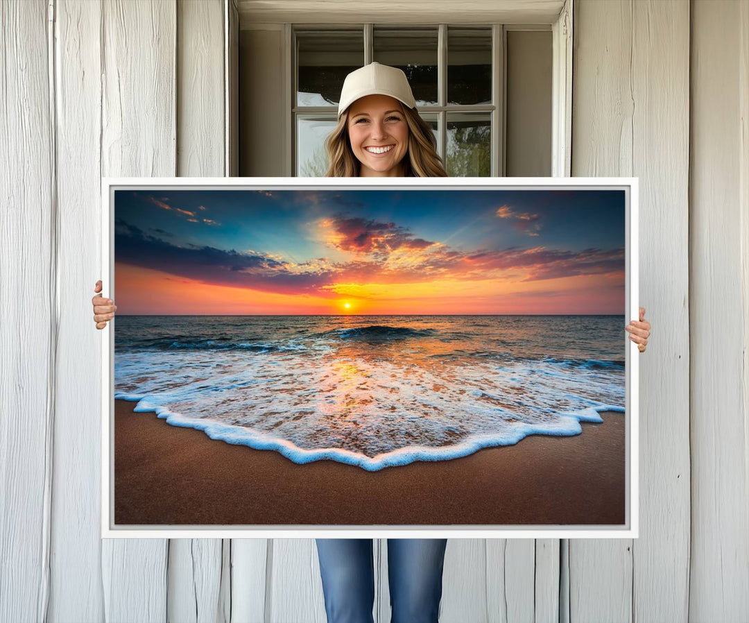 A Sunset with Calm Waves on the Beach Wall Art Canvas Print adorns the dining room.