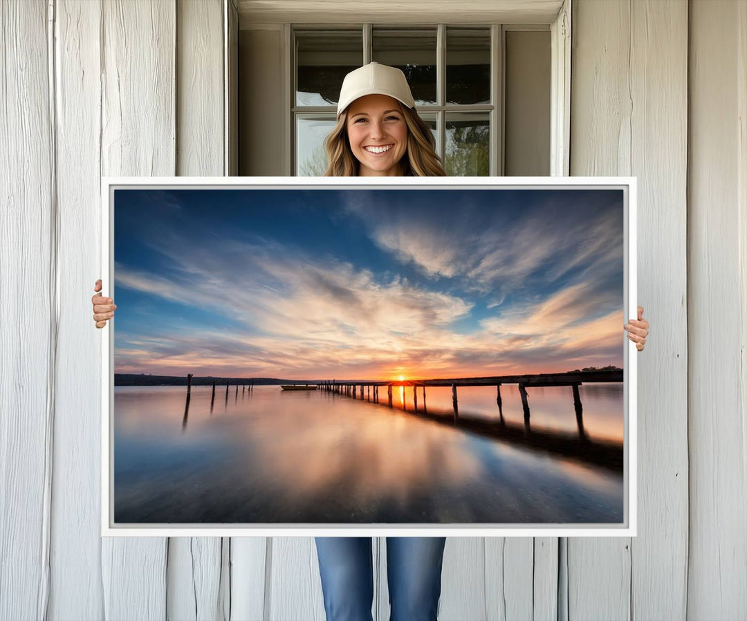 The Sunset Pier Canvas features a serene coastal landscape with vibrant hues under cloudy skies, ideal for modern decor.