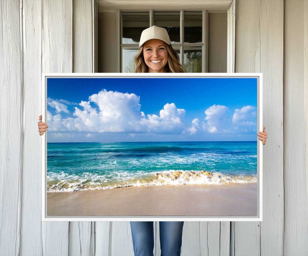 The Tropical Beach 3-Panel Canvas Wall Art features ocean waves gently lapping on a beach under blue skies, making it an ideal choice for coastal decor.