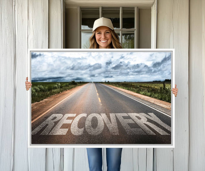 The Recovery Road Wall Art Canvas Print depicts a road under a cloudy horizon.