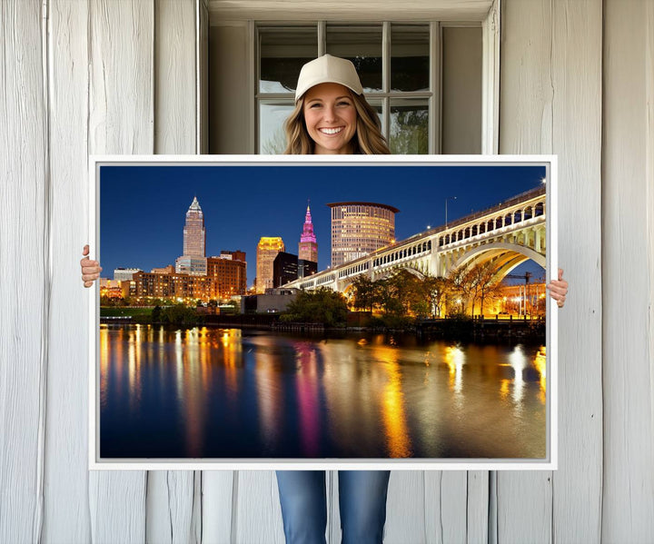 Cleveland Night Skyline Canvas: Cityscape with an illuminated bridge reflecting on calm water.