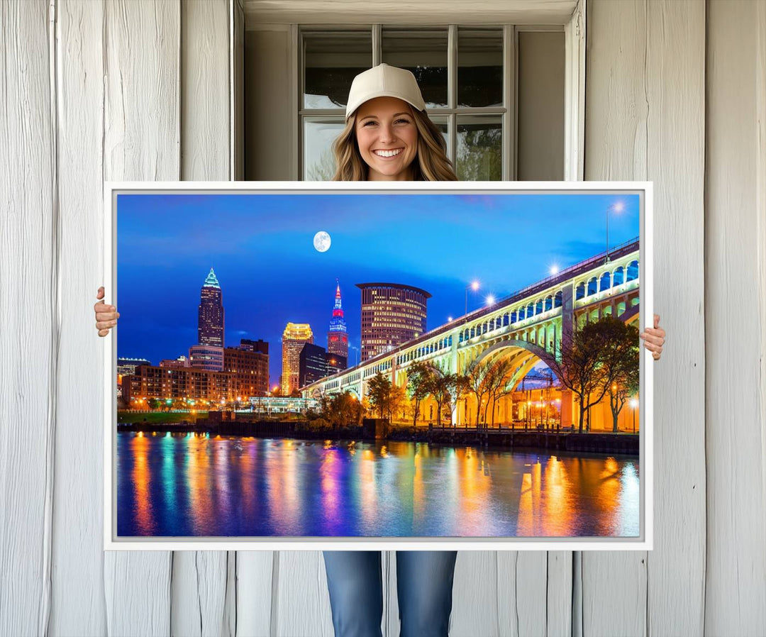 A Cleveland Night Skyline Wall Art on museum-quality canvas showcases a bridge and illuminated buildings.