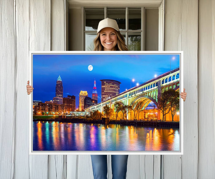 A Cleveland Night Skyline Wall Art on museum-quality canvas showcases a bridge and illuminated buildings.