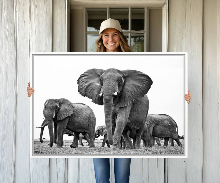 A modern dining area features a Black White Elephant Family Wall Art Canvas Print.