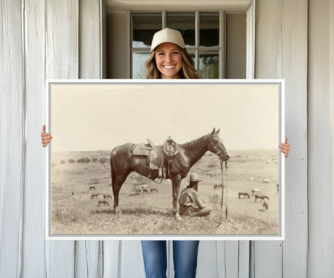 Cowboy Wall Art - Vintage Western Horse Canvas Print features a cowboy kneeling by his horse in a field.