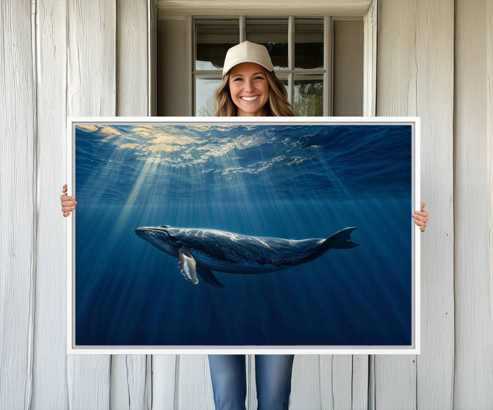 The Whale under Ocean wall art canvas print graces the white wall.