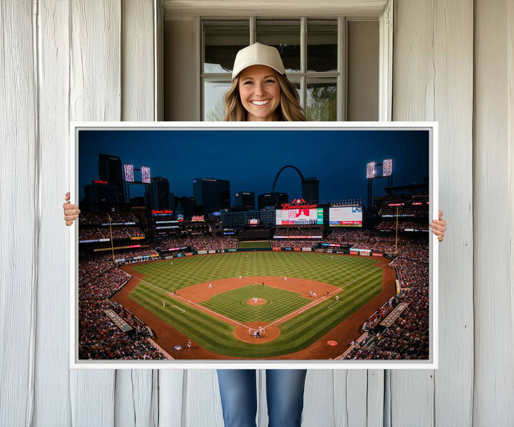 A St. Louis Cardinals Baseball Team print of Busch Stadium at night adorns the wall.