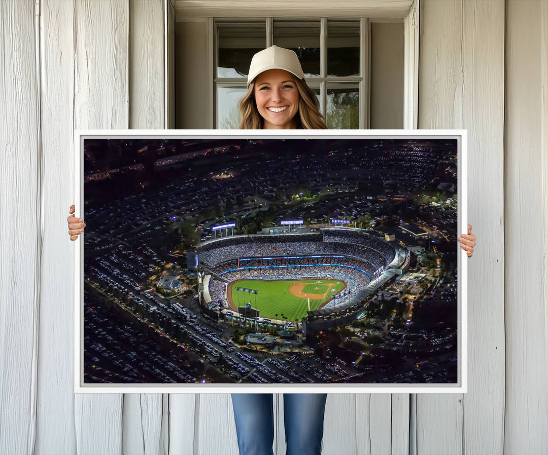 A large Los Angeles Dodgers print of Dodger Stadium at night is displayed near a window.