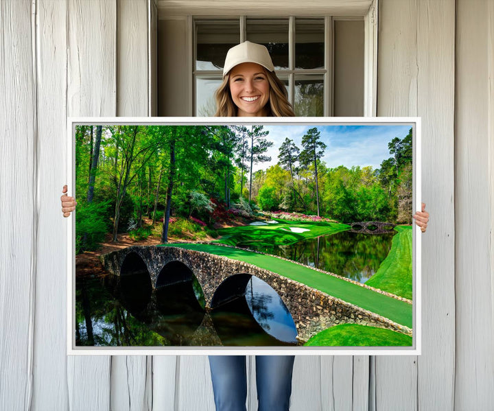 The wall art from Augusta National Golf Club showcases a panoramic bridge set against rich, lush greenery on a framed triptych canvas.