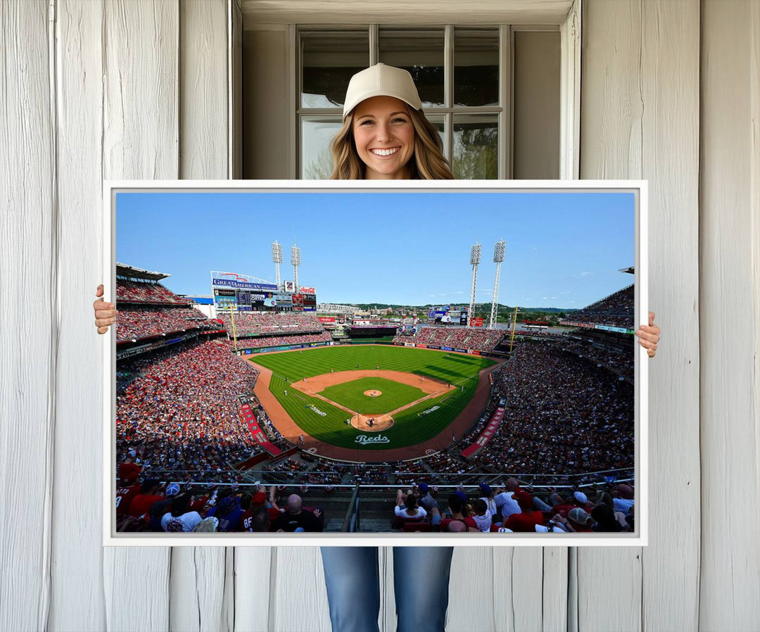 The Cincinnati Reds Baseball Team print of Great American Ball Park Stadium adorns the wall.