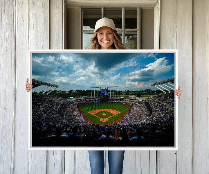 A 3-panel print of Kauffman Stadium, showcasing a crowded baseball field under cloudy skies.