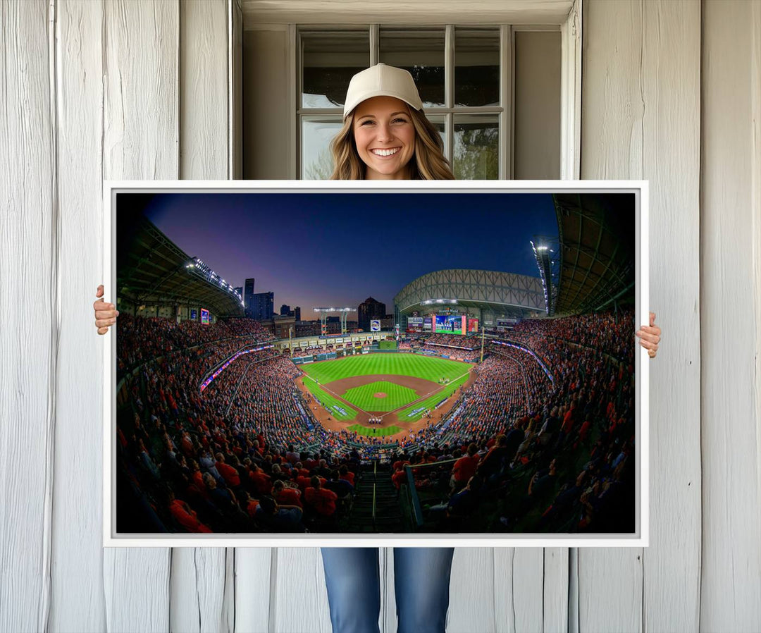 A canvas print of Houston Minute Maid Park at dusk is mounted on the wall.