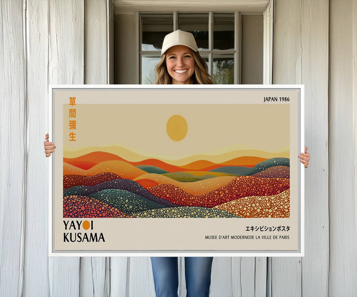 The Yayoi Kusama Wall Art Print is a vibrant abstract landscape canvas featuring colorful dotted hills and a sun, showcasing Japanese art and signed by Yayoi Kusama. It is dated Japan 1986.