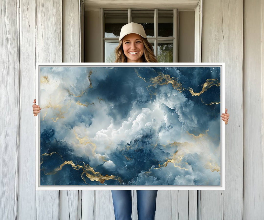 The "Large Abstract Print - Luxe Blue and Gold Abstract Canvas Wall Art" features a bold cloudscape design with swirling white patterns, ideal for modern home decor in living rooms or offices.