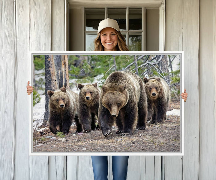 The Grizzly 399 and Cubs in Wild Flowers Wall Art Canvas Print, depicting grizzly bears amidst wildflowers, is elegantly displayed.