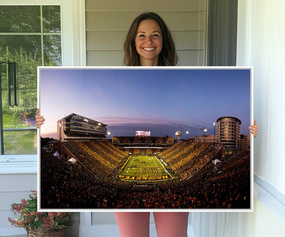 The Iowa Hawkeyes Kinnick Stadium Wall Art Canvas Print captures a sunset scene, making it perfect for display on a wall.