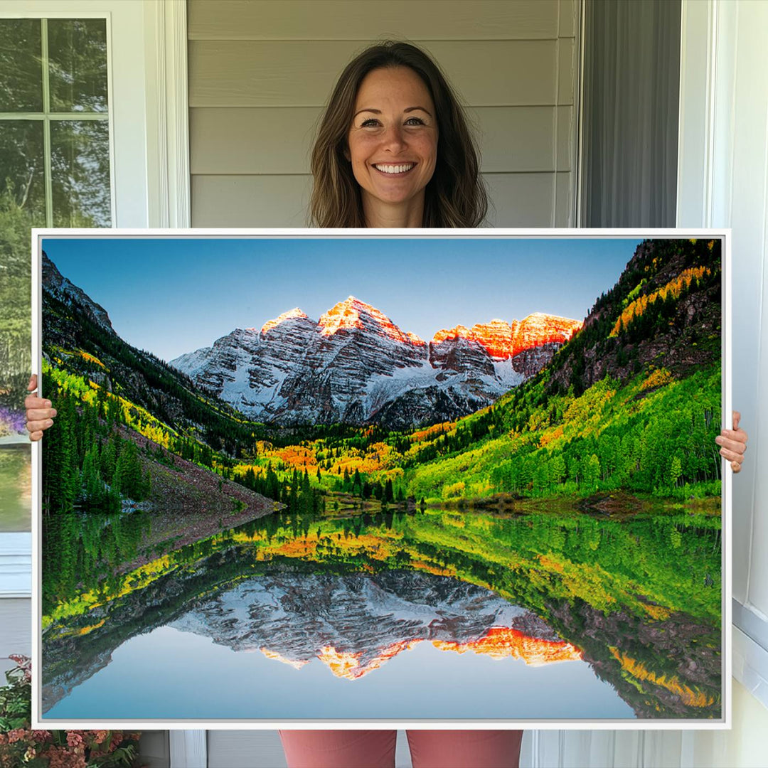 The Sunrise Maroon Bells Lake Wall Art Print beautifully captures North Maroon Peak mirrored in the tranquil lake, framed by lush greenery.