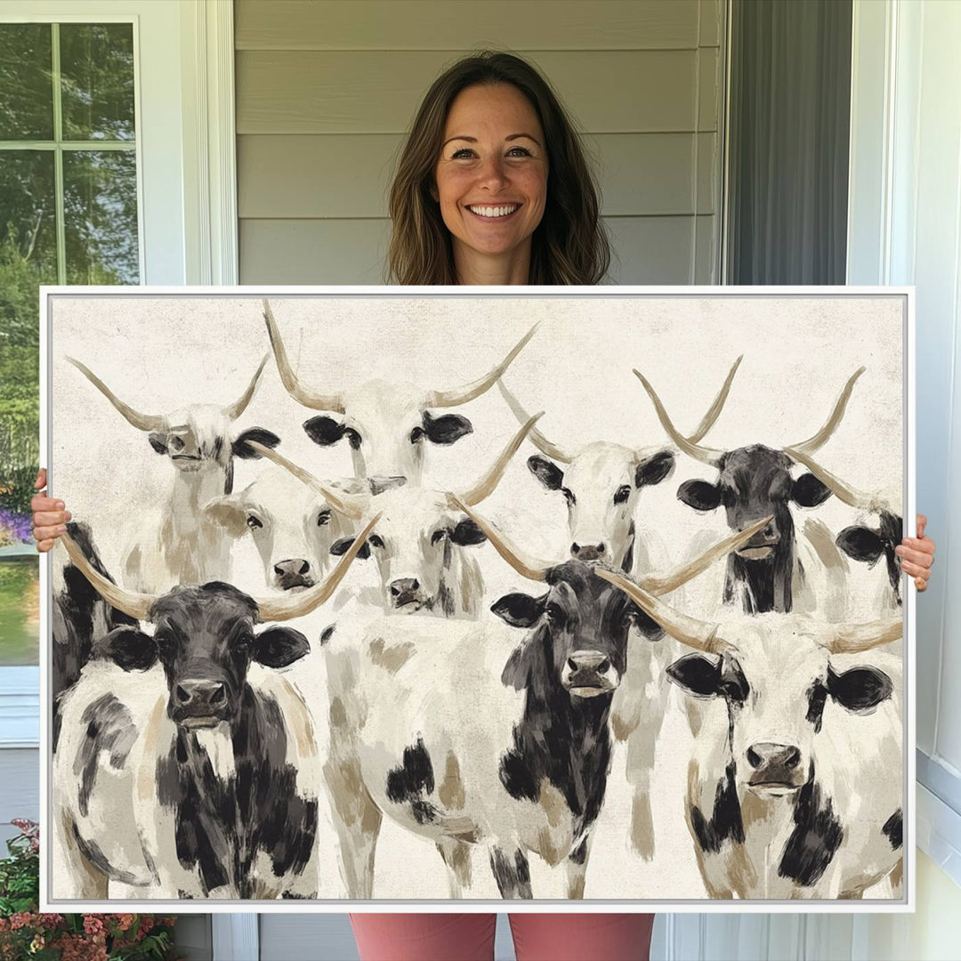 Canvas print titled Longhorn Texas Cow Drawing, depicting longhorn cattle with black and white markings, made in the USA, displayed on the wall.