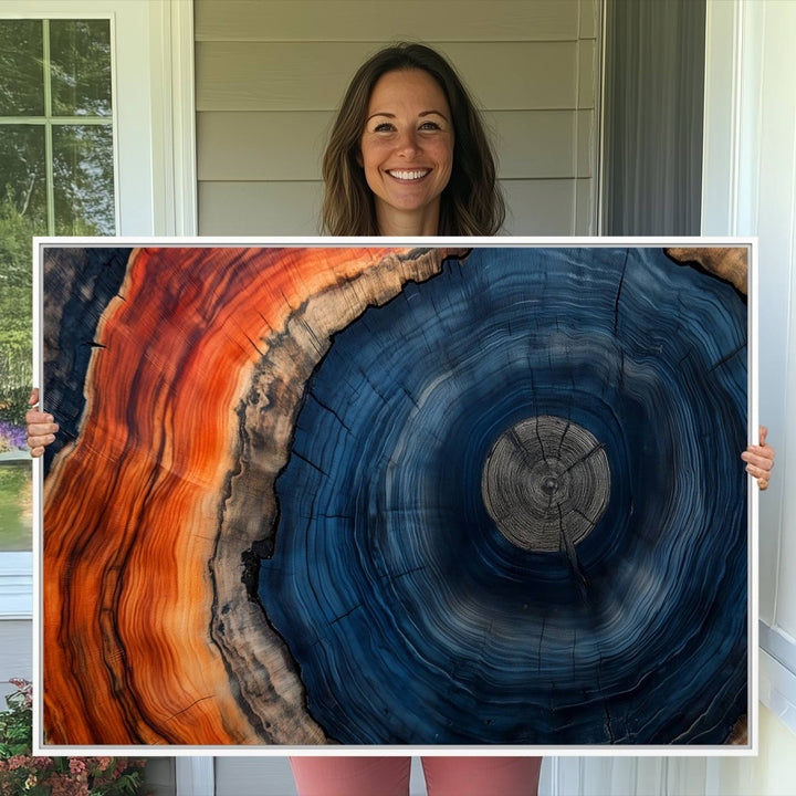 Abstract Tree Ring Wall Art Print on canvas featuring vibrant blue, orange, and brown rings with a natural rustic wood texture. Free shipping available!.