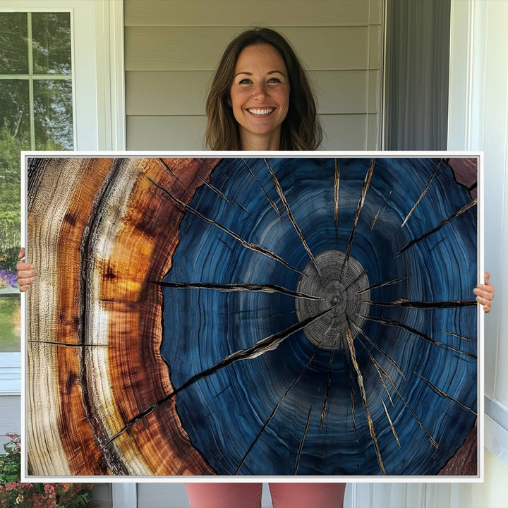 The Abstract Tree Rings Canvas Print features blue, brown, and orange rings that highlight wood grain and natures beauty.