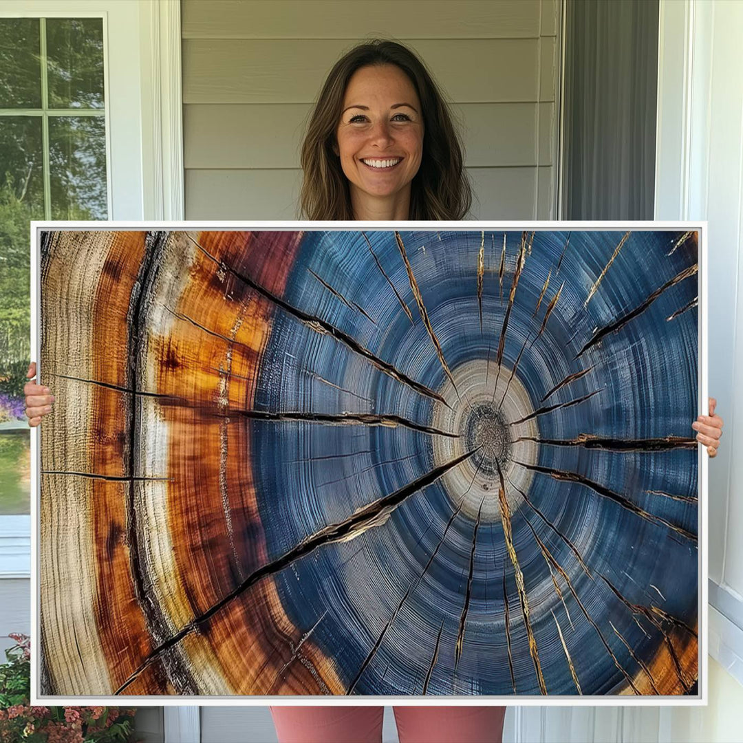 Close-up of blue, brown, and orange wood grain rings on the Abstract Tree Rings Canvas Wall Art Print.