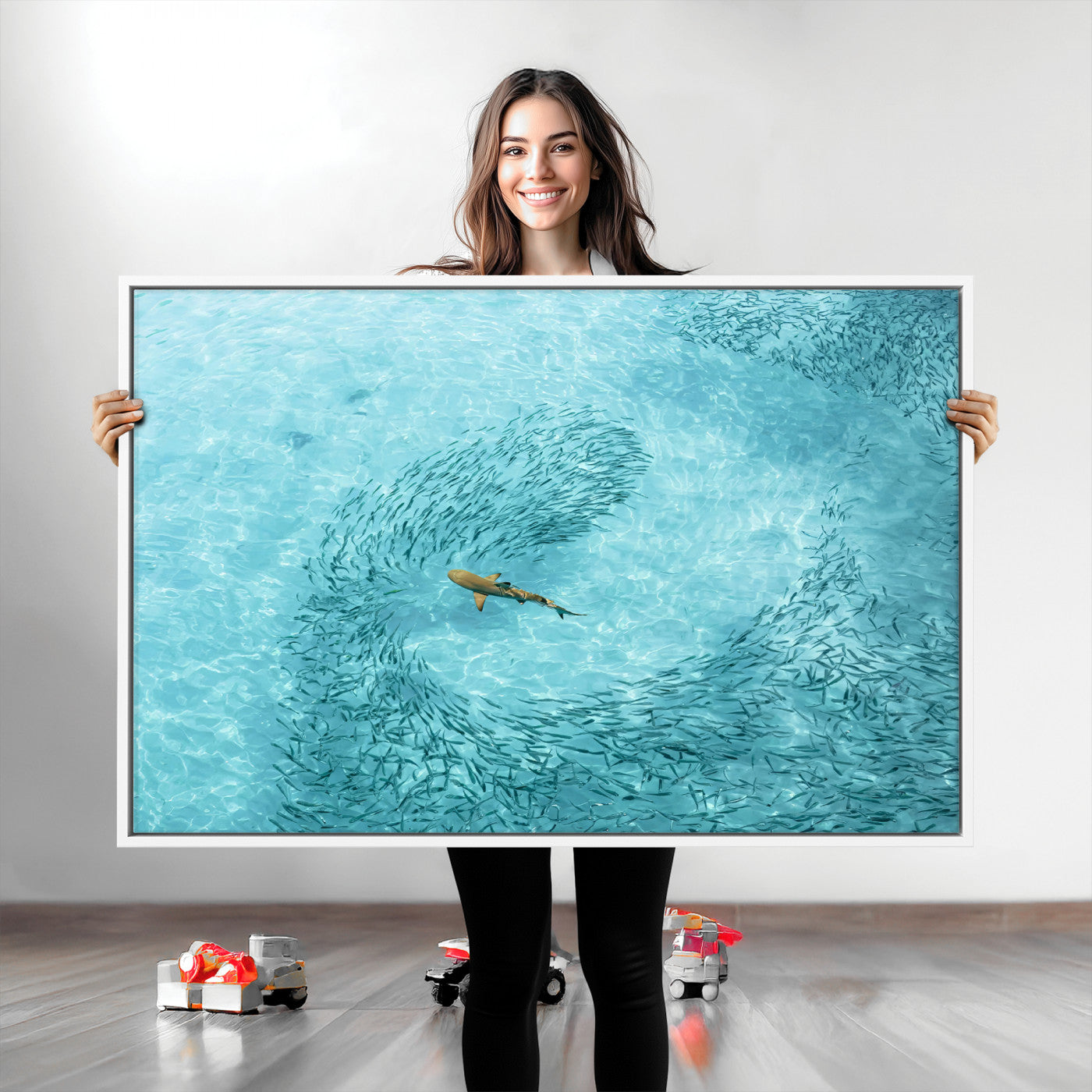 Aerial view of a shark swimming through a swirl of fish in clear turquoise waters, perfect for calm coastal or beach house decor.