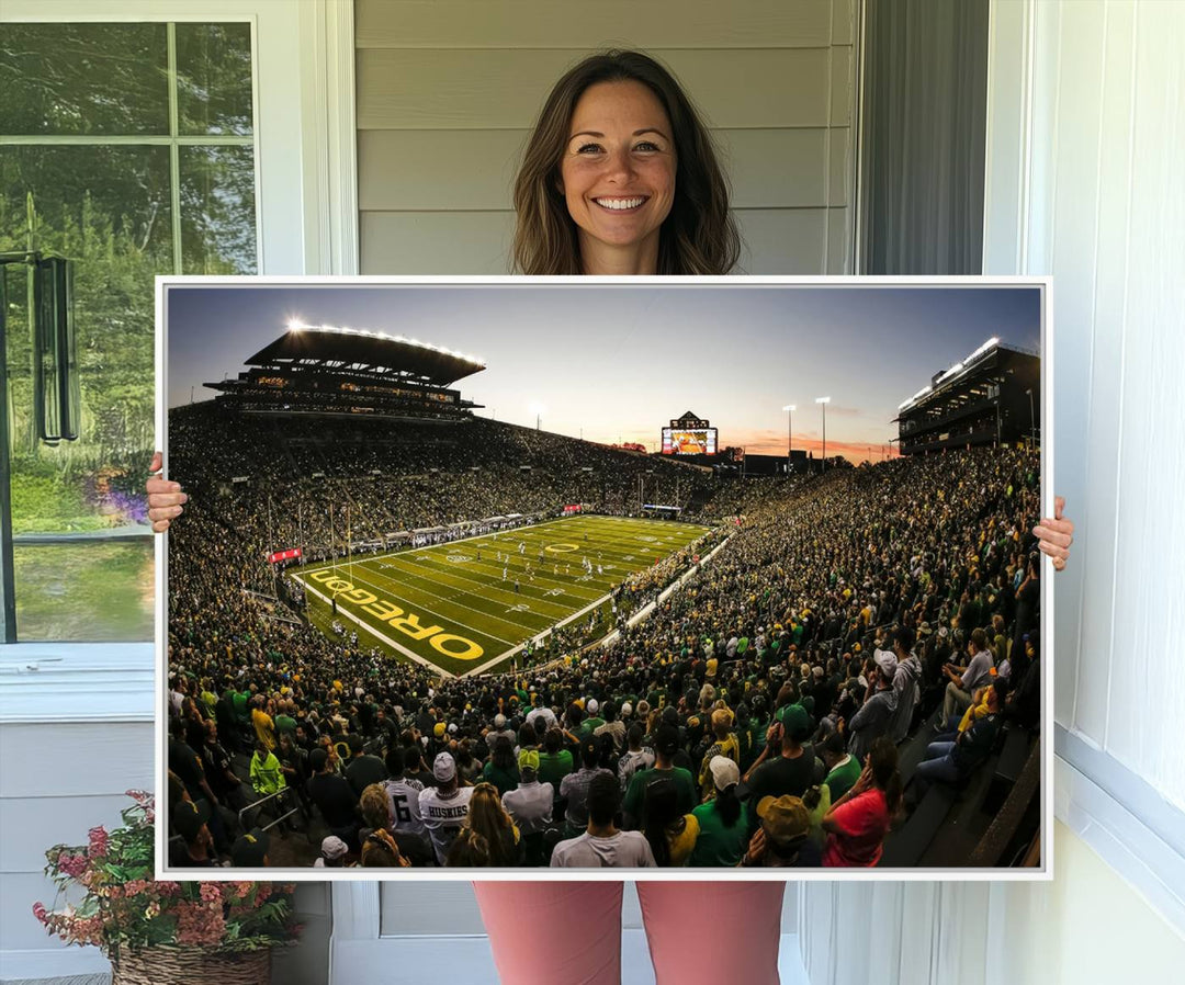 The Oregon Stadium Canvas Wall Art features a depiction of a packed Autzen Stadium with OREGON prominently displayed on the field.