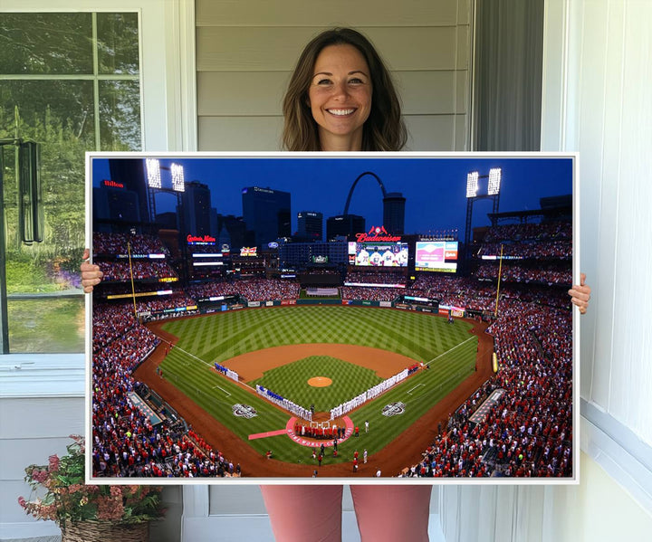 A Cardinals wall art canvas print depicts Busch Stadium with players lined up on the field and a full audience under the lights, capturing the vibrant atmosphere.