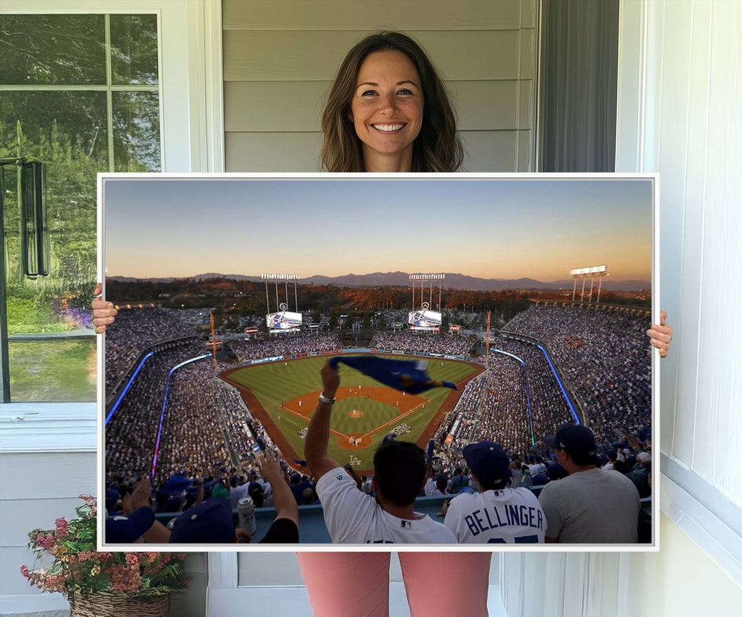 A triple canvas wall art captures the scene at Dodger Stadium, with fans cheering as the sun sets and a flag waving on the field.