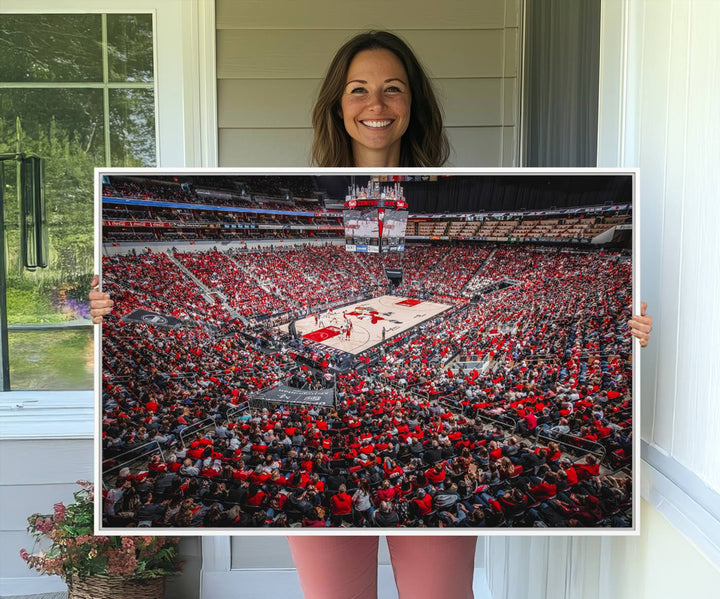 A painting of Louisville Cardinals fans in red at the KFC Yum Center Arena.