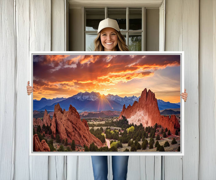 A vibrant sunset over the Rocky Mountains with red rocks.