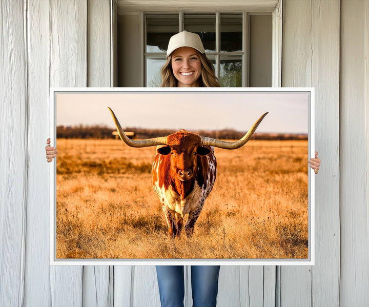 The Longhorn Cow Wall Art framed canvas brings rustic charm and farmhouse decor with its warm field scene.