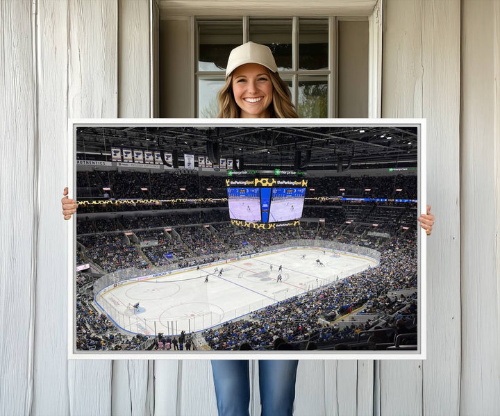 A large Enterprise Center canvas of a crowded hockey arena hangs prominently.