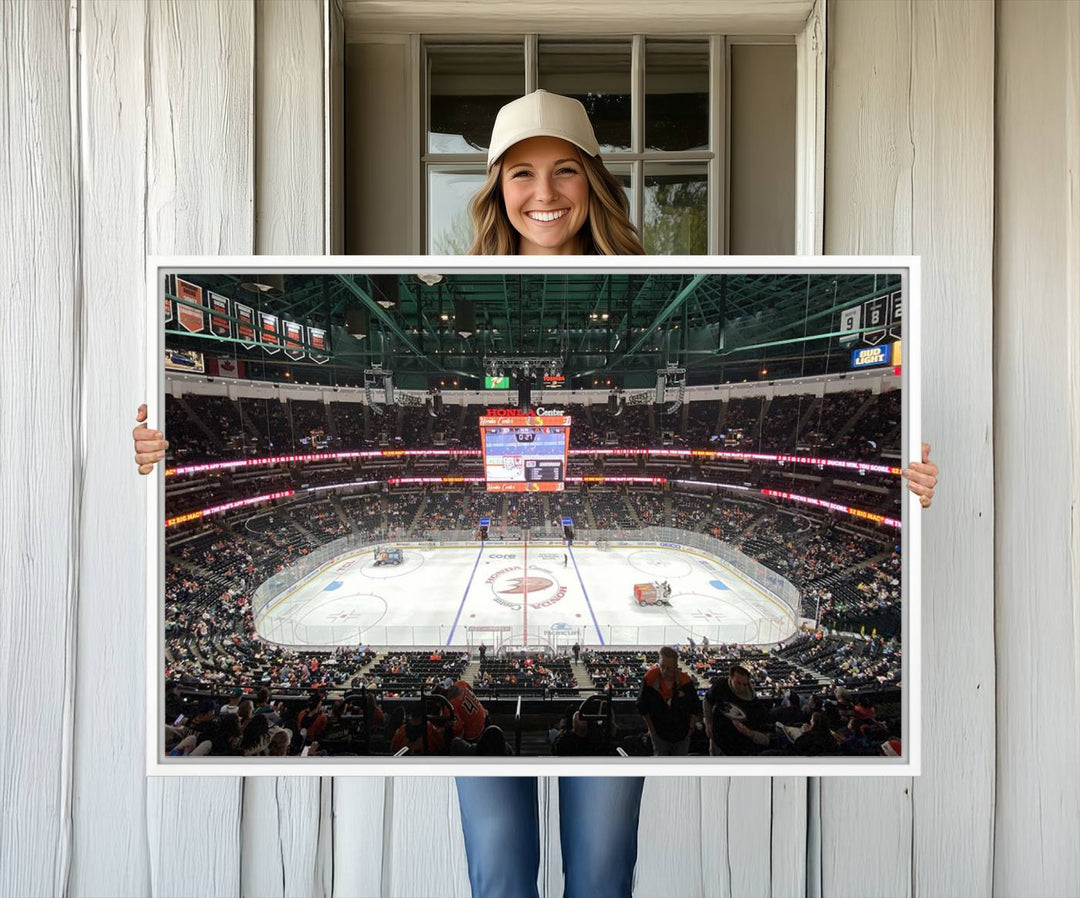 The wall art of the Honda Center California Anaheim Ducks Ice Hockey Stadium features a depiction of the rink and scoreboard from the perspective of the upper deck.