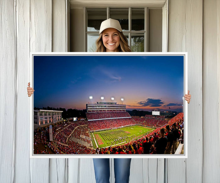 A vibrant and dynamic painting captures the essence of an electrifying night game at Carter-Finley Stadium, highlighting the illuminated atmosphere as the NC State Wolfpack competes under bright stadium lights.