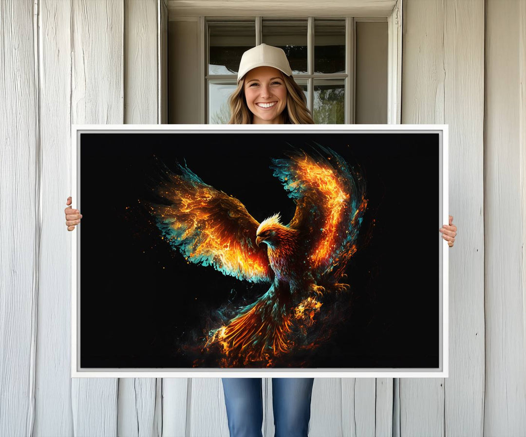 The Fiery Phoenix Canvas Print, showcasing a majestic bird with fiery wings against a black background, makes for the perfect bold decor in your living room.