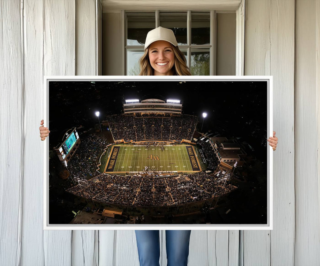 Canvas wall art displays an aerial view of Wake Forest Demon Deacons stadium at night.