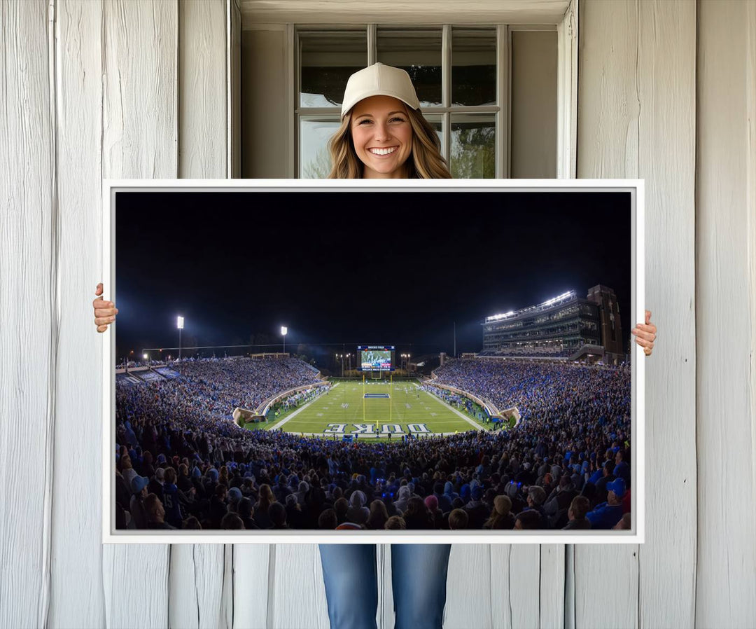 Under bright lights at night, the Duke Blue Devils Football Team Durham canvas wall art print is prominently displayed.