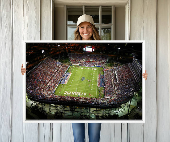 Gallery-quality wall art complements the view of the FAU Stadium with Florida Atlantic University Owls on the field in a night aerial setting.