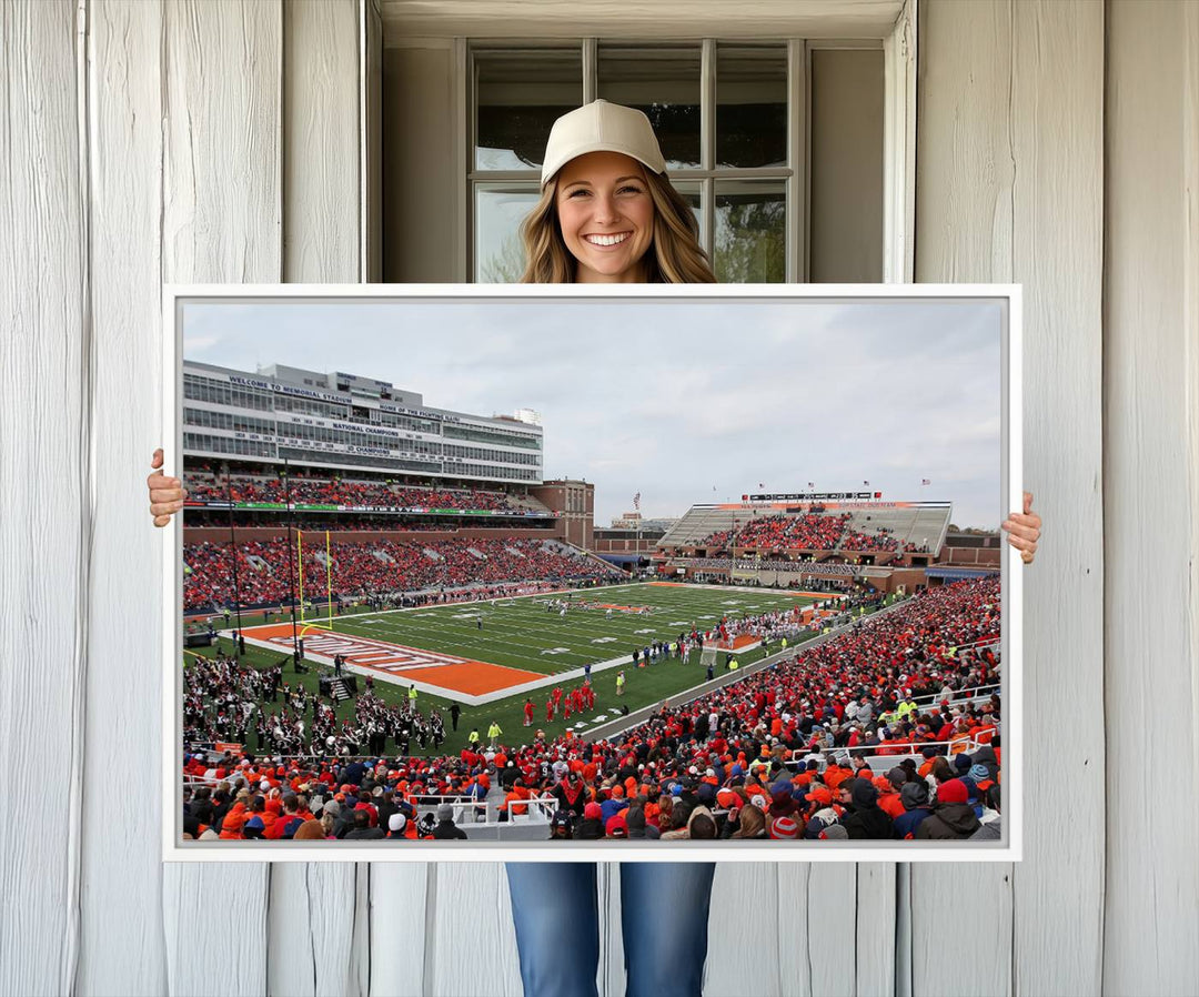 A University of Illinois Fighting Illini wall art canvas hangs on the wall, depicting a packed stadium.