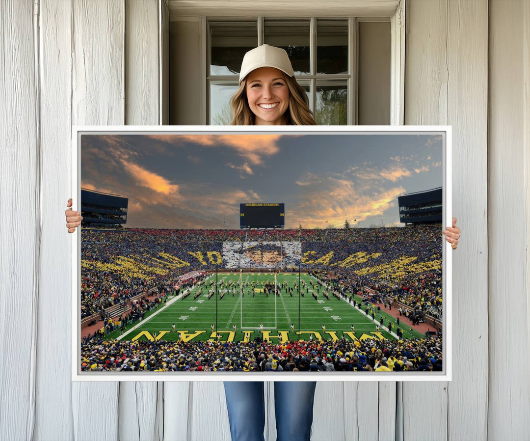 A giant image resembling Michigan Wolverines Wall Art depicts a football field beneath a dramatic sky.