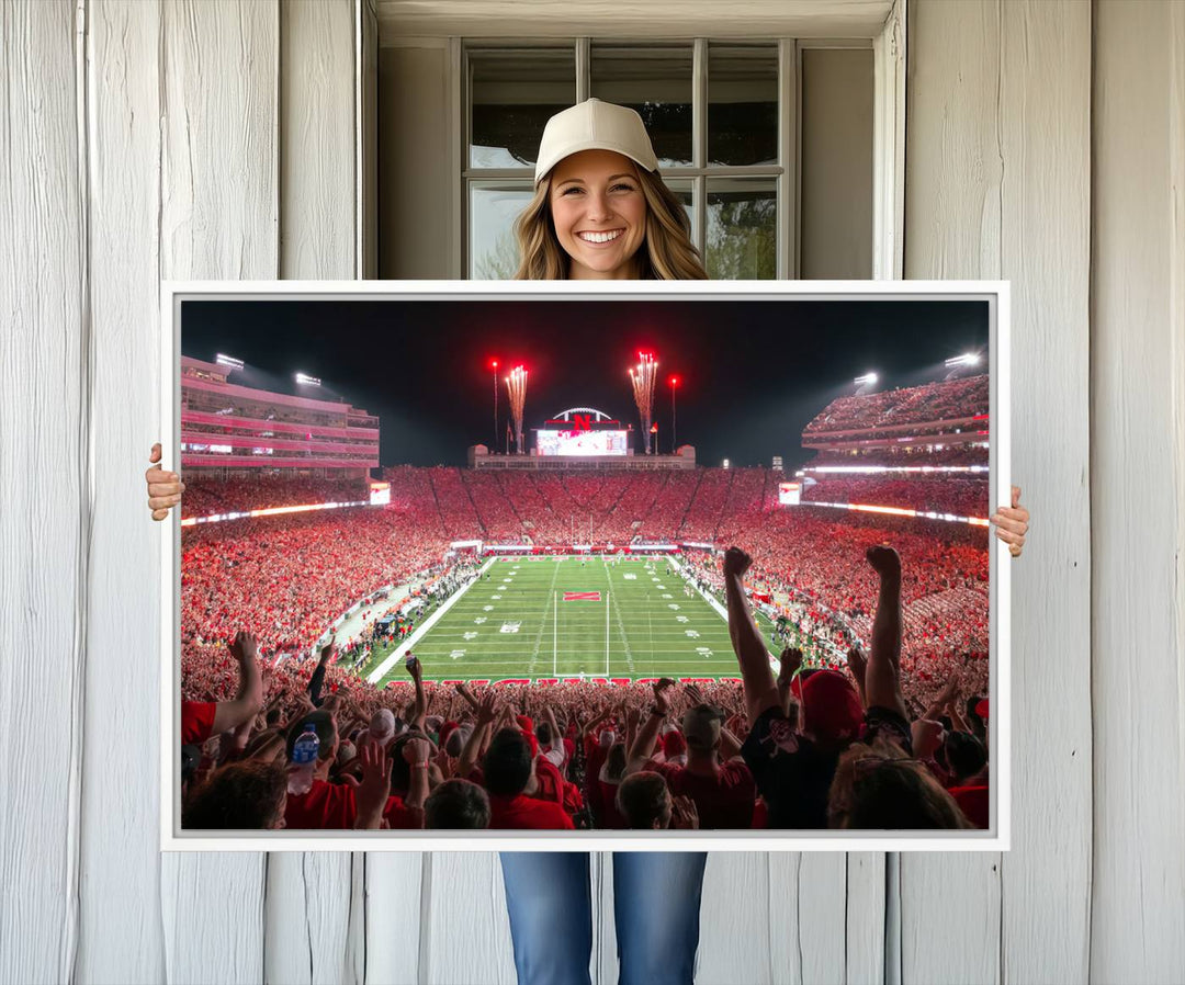 A vibrant canvas print of the Lincoln Memorial Stadium at night with fireworks, featuring the University of Nebraska Cornhuskers Football.