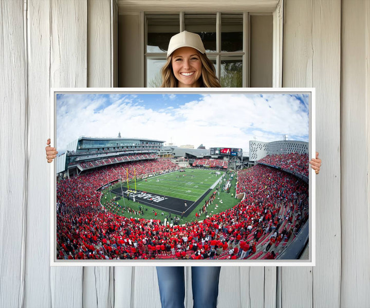 The wall showcases a Nippert Stadium canvas print of the Cincinnati Bearcats.