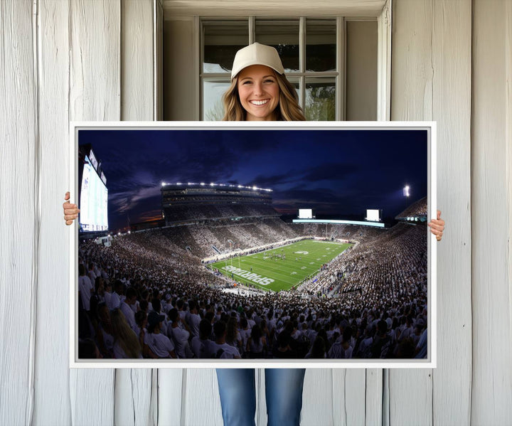 A packed football stadium at night, with bright lights and fans in white, depicted in a Michigan State Spartans Stadium wall art.