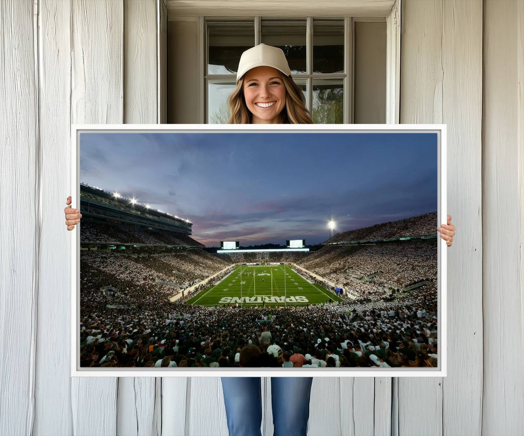 Wall art featuring a stadium at dusk with full stands—ideal for the Michigan State Spartans Football Team Canvas Print.