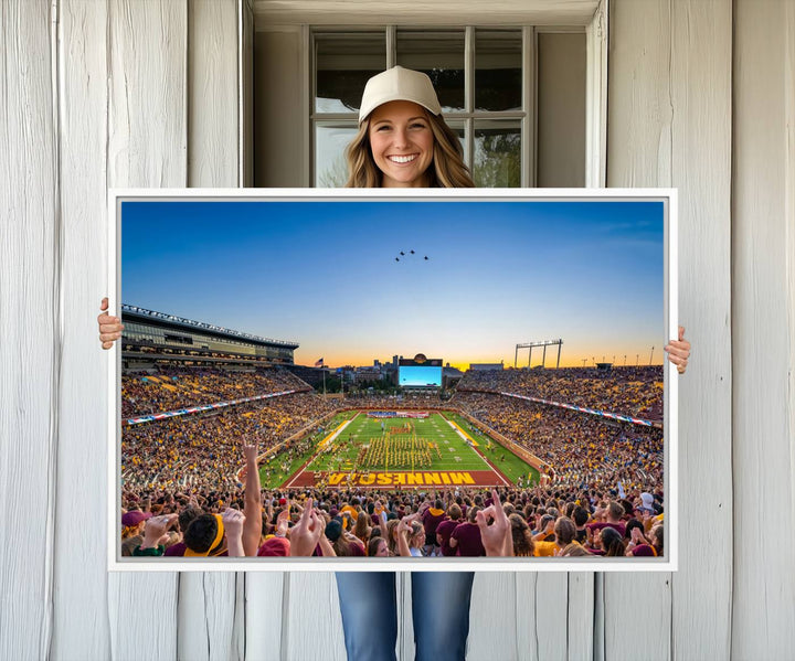 Canvas wall art featuring the University of Minnesota Football Team print, showcasing Huntington Bank Stadium at sunset with jets overhead.